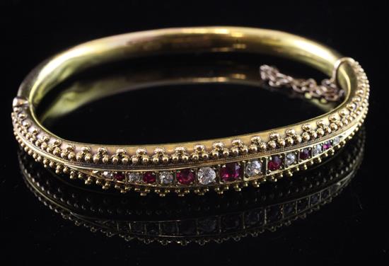 A late Victorian 15ct gold, ruby and diamond set hinged bracelet,